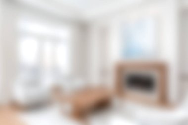 Bu resim, yumuşak doğal ışık ve minimalist dekorun yer aldığı modern bir oturma odasını tasvir ediyor. Davetkar alan ahşap aksanlar, şık mobilyalar ve rahatlama ve aile toplantıları için mükemmel sakin bir ortam içeriyor..