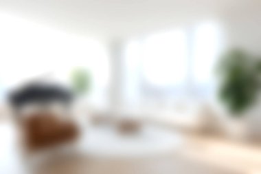 Bu resim, minimalist dekor, ferah yerleşim ve bol doğal ışık barındıran, huzurlu bir yaşam ortamı yaratan parlak ve rahat bir modern oturma odasını sergiliyor..