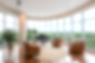 Doğal ışığı davet eden ve doğanın manzarasını gösteren geniş pencereli rahat modern yaşam alanı. Lüks mobilyalar rahatlatıcı bir ortam yaratır..