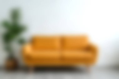 Parlak sarı kanepe modern bir oturma odasına sıcaklık ve tarz katar, bereketli bir iç mekan bitkisiyle tamamlanır, canlı ve davetkar bir atmosfer yaratır..