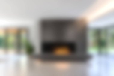 Bu resim modern minimalist oturma odasını gösteriyor şık bir şöminesi, büyük pencereleri ve geniş doğal ışığı olan, davetkar bir atmosfer yaratıyor..