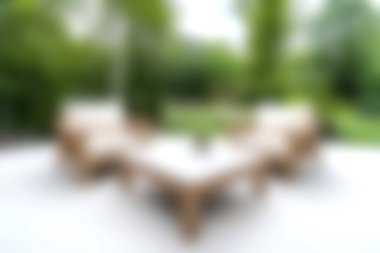 Bu resim canlı bir bahçede dikkatlice düzenlenmiş zarif bir açık hava mobilyası setine sahiptir. Sahne, huzur ve rahatlığı huzurlu bir ortama davet ediyor..