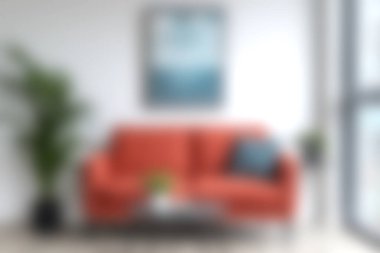 Parlak turuncu kanepe, minimalist dekor ve canlı yeşillik içeren şık bir oturma odası. Rahatlamak için mükemmel ve davetkar bir ortam yaratıyor..