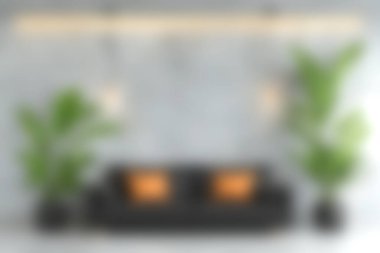 Bu resim şık dekorlu, sıcak ışıklandırmalı ve kapalı mekanlı rahat bir modern oturma odasını içeriyor, rahatlama ve toplanma için mükemmel sakin bir atmosfer yaratıyor..