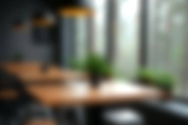 Bu görüntü, üretkenlik ve yaratıcılık için sakin bir atmosfer yaratan bitkilerin ve şık dekorun yer aldığı geniş doğal ışıkla rahat bir modern çalışma alanı yakalıyor..