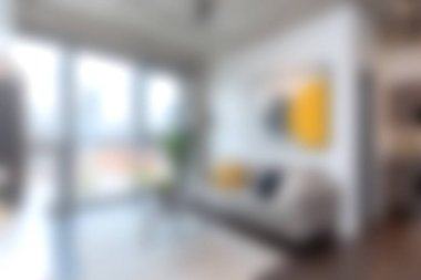 Rahat bir kanepe, canlı bir duvar sanatı ve geniş doğal ışık barındıran modern bir oturma odası. Çağdaş tasarımda rahatlatıcı bir atmosfer için mükemmel..