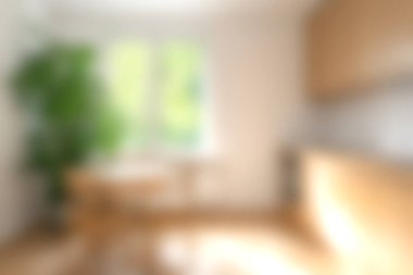 Bu resim, yeşil alandan süzülen doğal ışık içeren parlak ve havadar bir iç mekan sergiliyor. Modern tasarım sıcaklığı ve basitliği vurgular..