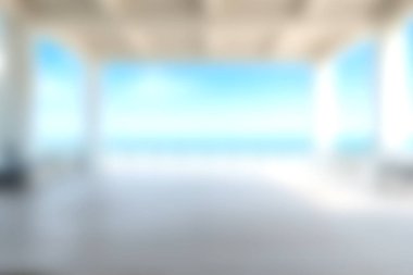 Zarif bir iç mekandan okyanusun huzurlu ve bulanık görüntüsü, parlak bir gökyüzü altında rahatlama ve sükunetin özünü yakalıyor..