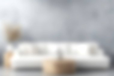 Yumuşak yastıklarla süslenmiş şık beyaz bir kanepenin olduğu huzurlu, modern bir oturma odası. Nötr tonlar rahatlamak için mükemmel sakin bir atmosfer yaratır..