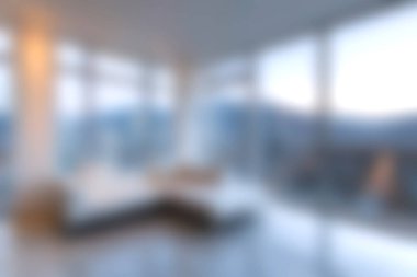 Geniş pencereli modern bir oturma odası çarpıcı dağ manzaralarını gözler önüne seriyor, doğal ışık ve konforla dolu huzurlu bir atmosfer yaratıyor..