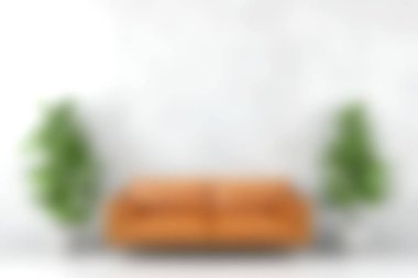 Tarafsız bir zemine karşı yemyeşil bitkilerle çevrili rahat kahverengi bir kanepenin bulunduğu modern oturma odası, sakin ve davetkar bir atmosfer yaratıyor..