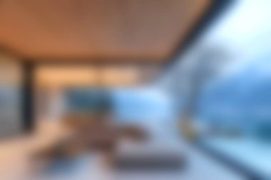 Bu resim, açık hava manzarası sunan geniş pencereli modern bir minimalist iç tasarım sergiliyor. Uzayda rahatlık ve sükunet vurgulanıyor..
