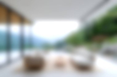 Bu resim, rahat bir oturma, rahatlama ve huzur dolu bir ortamda manzaranın keyfini çıkaran modern bir açık hava yaşam alanını gösteriyor..