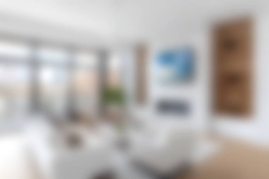 Bu modern oturma odası beyaz bir kanepe ve geniş pencereli parlak bir iç mekâna sahiptir. Havadar tasarım doğal ışığı davet ediyor, rahat ve davetkar bir alan yaratıyor..