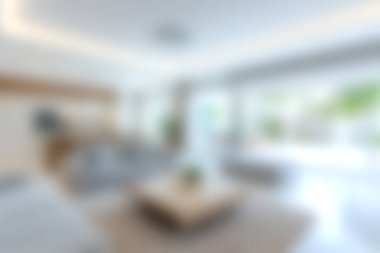 Bu resim doğal ışıkla dolu modern bir minimalist oturma odasını sergiliyor, rahat ve davetkar bir atmosferi ön plana çıkarıyor..