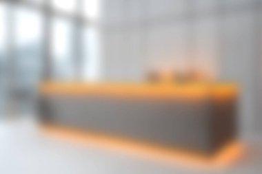 Çağdaş ofis ortamında yumuşak ortam ışıklandırmasının yer aldığı parlak ve modern bir kabul masası, minimalist tasarım unsurları ve profesyonel bir atmosferi sergiliyor..