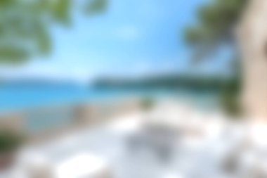 Experience the tranquility of a coastal landscape featuring clear waters, a blue sky, and inviting outdoor settings, perfect for relaxation and leisure activities.