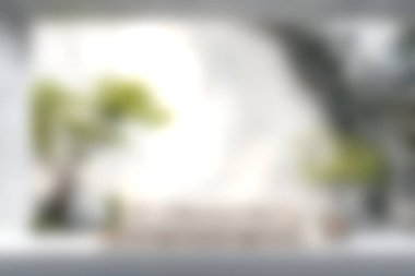 Modern mobilyaların ve yeşil bitkilerin bulunduğu parlak ve davetkar bir oturma odası. Rahatlamak ve sosyalleşmek için mükemmel bir hava ve huzur ortamı yaratıyor..