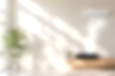 Parlak oturma odası yumuşak güneş ışığıyla yıkandı. Minimalist dekor, güzel bir bitkiyle davetkar bir atmosfer yaratır. Rahatlamak için ideal.