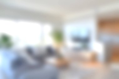 Modern mobilyaların, büyük pencerelerin ve şık dekorların bulunduğu parlak ve rahat bir oturma odası rahatlama ve rahatlamaya davet eden bir ortam yaratıyor..