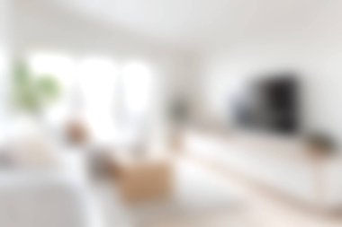 Parlak, minimalist tasarım unsurlarının bulunduğu, samimi ve davetkar bir atmosfer yaratan modern bir oturma odası. Doğal ışık boşluğu doldurur, atmosferi güçlendirir..