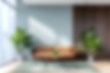 A modern living room featuring a stylish sofa and lush greenery, bathed in soft natural light, creating a serene and inviting atmosphere perfect for relaxation.