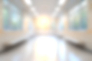 A softly blurred image of a bright hallway showcasing natural light and serenity. The inviting atmosphere highlights the beauty of modern design and architecture.