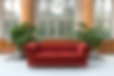 Cozy red sofa positioned in a bright living room filled with natural light and lush plants. Ideal for home decor inspiration and interior design ideas.