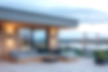 A serene outdoor living space showcasing comfortable furniture set against a mesmerizing water view during dusk. Perfect for relaxation and harmony.