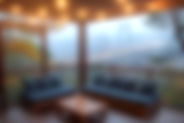 A serene indoor seating area featuring wooden elements and warm lighting, perfect for relaxation in a mountainside retreat. Enjoy the scenic view.