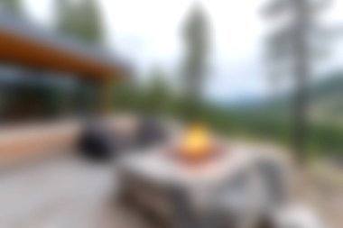 Experience the serenity of a cozy outdoor fire pit area, perfect for relaxation and gatherings. Modern furniture complements scenic views in this tranquil setting.