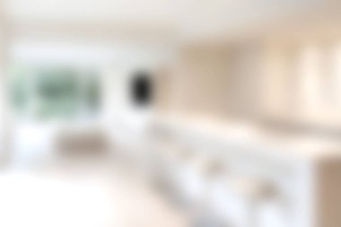 This image features a bright modern kitchen with a minimalist design, showcasing natural light and a clean aesthetic ideal for contemporary living.