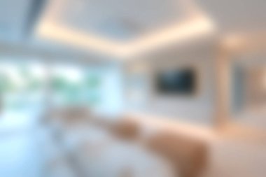 Bu modern oturma odası görüntüsü bulanık bir estetik ve yumuşak ışıklandırmayla barışçıl bir ortam yaratıyor. Tasarım ve dekor projeleri için ideal.