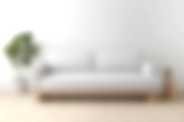 Rahat, minimalist bir kanepe, bereketli bir saksı bitkisiyle tamamlanmış, parlak bir oturma odası ortamında, davetkar ve şık bir atmosfer yaratıyor..