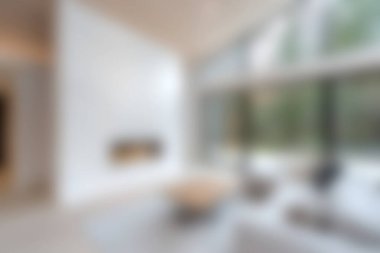 Bu modern oturma odasında doğal ışık getiren büyük pencereler, minimalist mobilyalar ve rahatlamak ve rahatlamak için mükemmel bir ortam var..