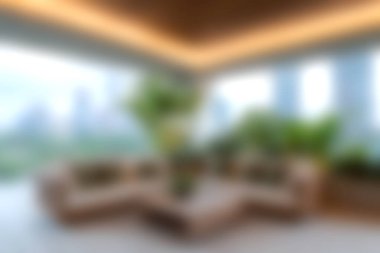 Modern bir oturma odasında şık mobilyalar ve ev bitkileri, doğal ışık ve sükunet dolu rahat ve davetkar bir atmosfer yaratıyor..