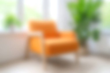 Işıl ışıl yeşil bitkiler ve doğal ışık ile çevrili parlak bir odaya yerleştirilmiş rahat bir turuncu aksanlı sandalye, sakin bir atmosfer yaratmak için mükemmel..