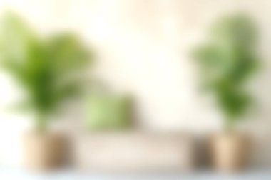 İçerideki yemyeşil bitkilerin ve minimalist dekor elementlerinin olduğu rahat bir oturma odası sahnesi. Her evde rahatlatıcı ve davetkar bir atmosfer yaratmak için mükemmel..