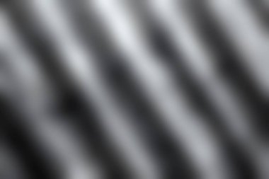 Gölgeler ve ışık desenleri içeren dokulu bir yüzeyin soyut tasviri. Bu kompozisyon tarafsız tonlara odaklanarak basitliği ve modern tasarımı vurgular..