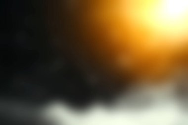 Karmaşık soyut görüntü, parlak toz parçacıkları sergiliyor. Ilık altın ışıkla aydınlatılıyor. Karanlık bir arkaplanda büyüleyici bir görsel efekt yaratıyor..