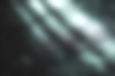 Yumuşak doğal ışıkla aydınlatılan karanlık bir yüzeye yakından bakmak çarpıcı gölgeler ve desenler yaratır. Işık ve doku oyunu, sükunet ve minimalizm duygusunu çağrıştırıyor..