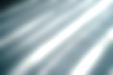 Bu resim, yumuşak doğal ışığı modern bir mekanda açık renkli fayanslar üzerinde uzun gölgeler oluşturarak minimalist tasarımı vurgular..