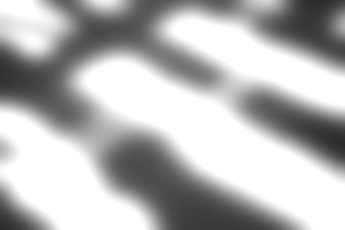 Pürüzsüz bir yüzeyde ışık ve gölgenin büyüleyici etkileşimi soyut bir perspektif sunarak sanatsal ifade ve minimalizmi çağrıştıran dinamik desenler yaratır..