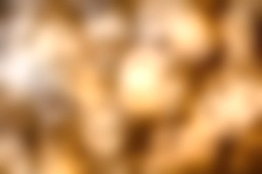 Bulanık ışıkların büyüleyici bir görüntüsü sanatsal arka plan için mükemmel, sıcak bir bokeh etkisi yaratır. Altın tonlar her tasarıma sıcaklık ve zarafet katar..