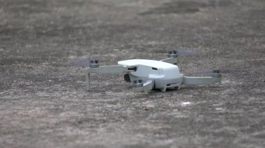 Drone taking off from a plane surface at sunset.