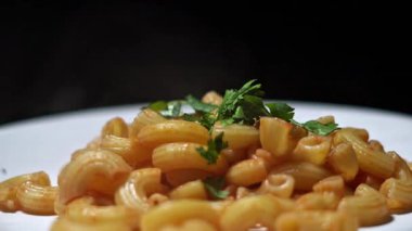 hot pasta with tomato sauce and coriander leaves.