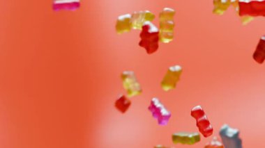 Çoklu jelibon ayılarının bir pastel zemine düşerek hareketli, parlak renklerle ve yaratıcı veya ticari planlar için mevcut kopya alanlarından esinlenerek neşeli bir şeker oluşturan üç boyutlu bir animasyon..