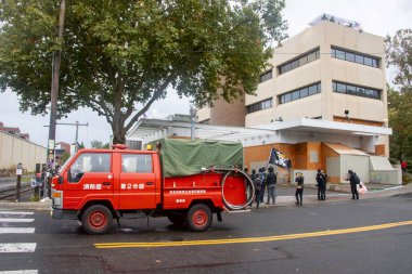 PORTLAND, OR - OCTOBER 11:  A local Japanese Fire Truck honks supporting the Portland protests, some in inflatable costumes in the rain outside the U.S. Immigration detention facility, with unanimous support from the Governor, Mayor, and City Council