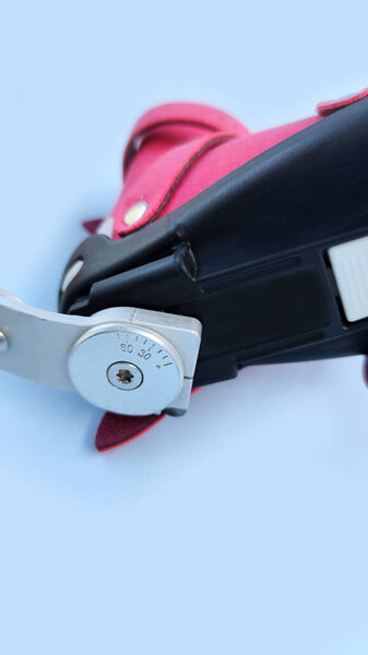 Portrait view close-up of orthopedic boot attached to adjustable metal bar brace, demonstrating clubfoot correction mechanism for infants.