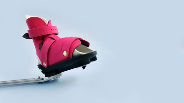 Close-up front view of orthopedic boot attached to adjustable metal bar brace, demonstrating clubfoot correction mechanism for infants.
